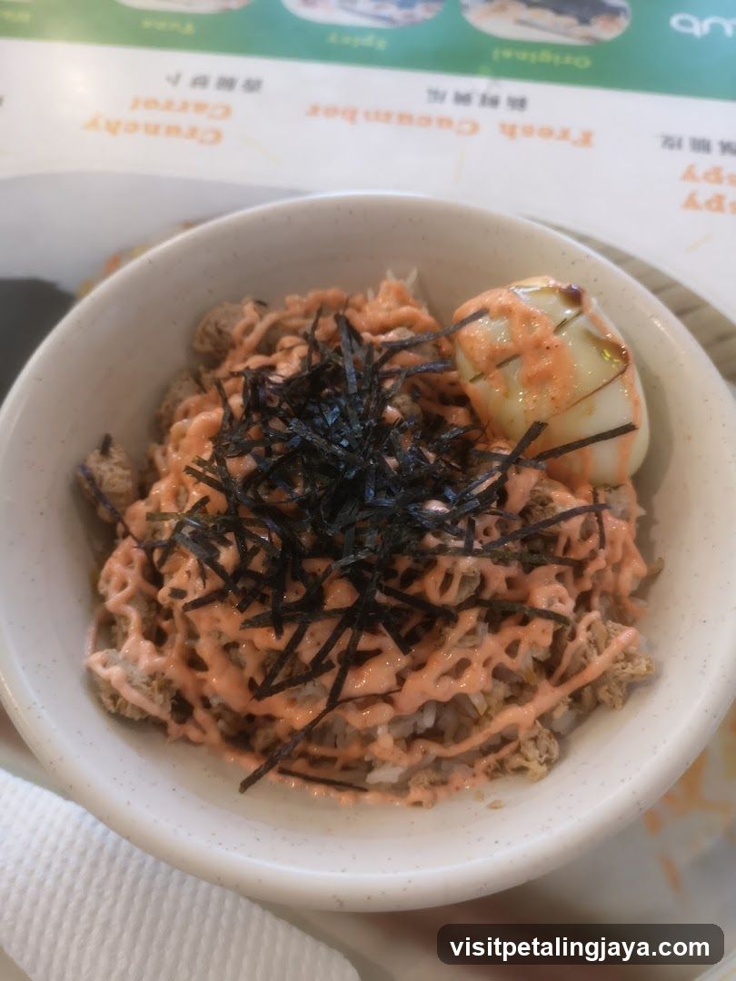 Bowl of rice with sauce and seaweed