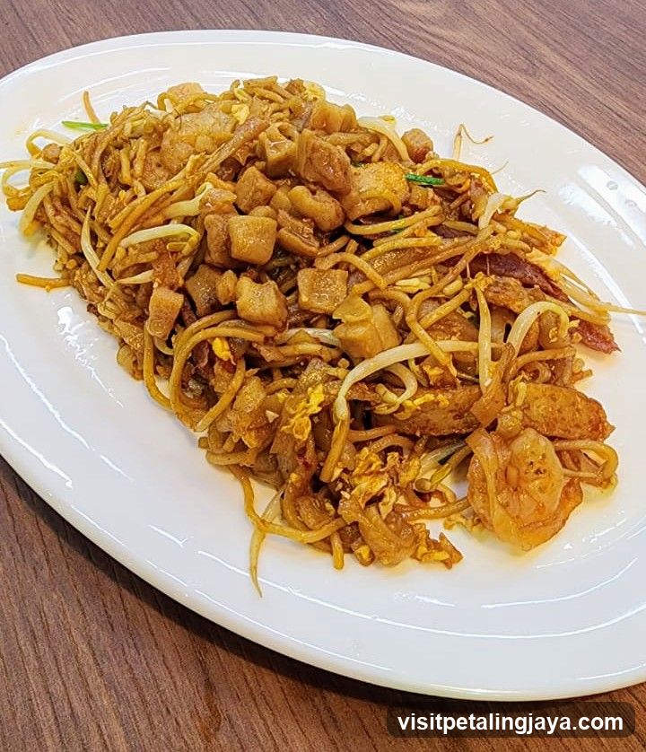 Pad See Ew or similar stir-fried noodles dish
