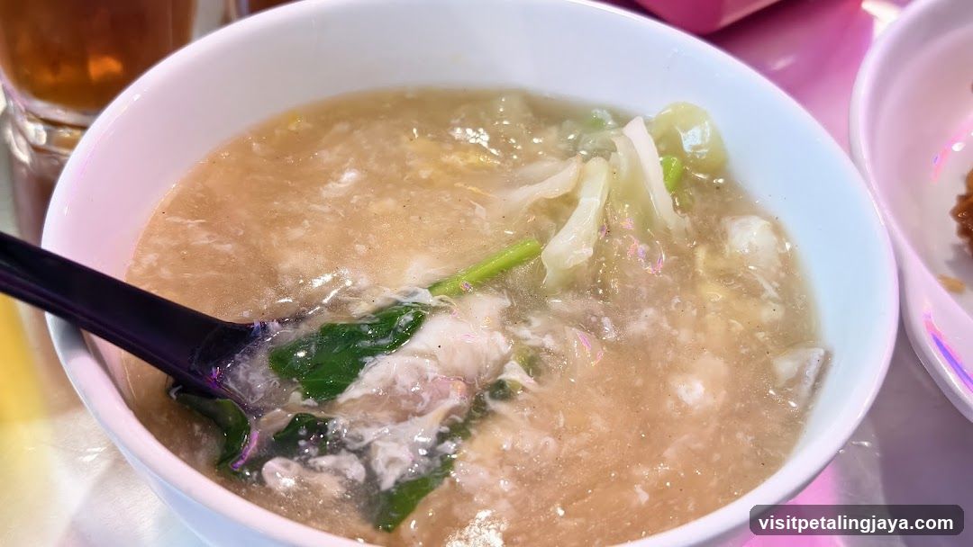 Bowl of congee with vegetables and meat