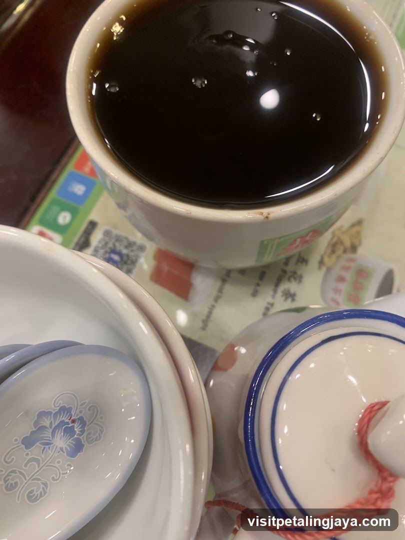 Bowl of dark liquid with tea set